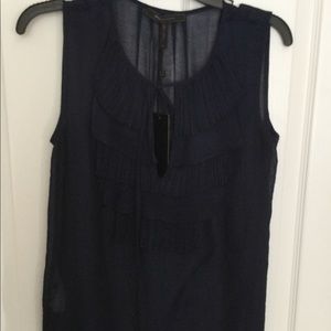 BCBG navy blue top with ruffled front and tie.